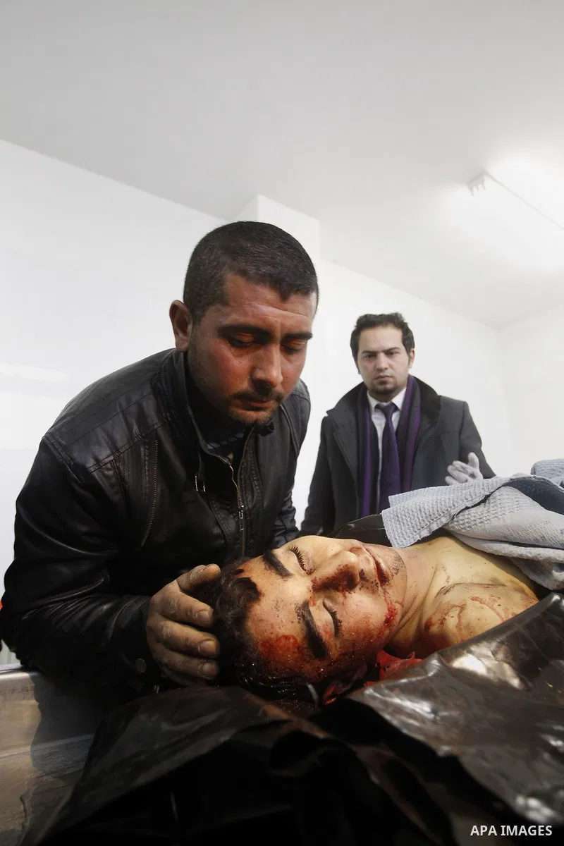 Palestinians mourners gather around the body of 18-year-old Ahmad Younis Kawazba at a hospital in the West Bank city of Hebron on Jan. 05, 2016. Kawazba was shot dead after he reportedly stabbed an Israeli soldier at the...