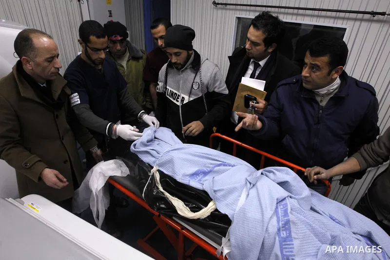 Palestinians mourners gather around the body of 18-year-old Ahmad Younis Kawazba at a hospital in the West Bank city of Hebron on Jan. 05, 2016. Kawazba was shot dead after he reportedly stabbed an Israeli soldier at the...
