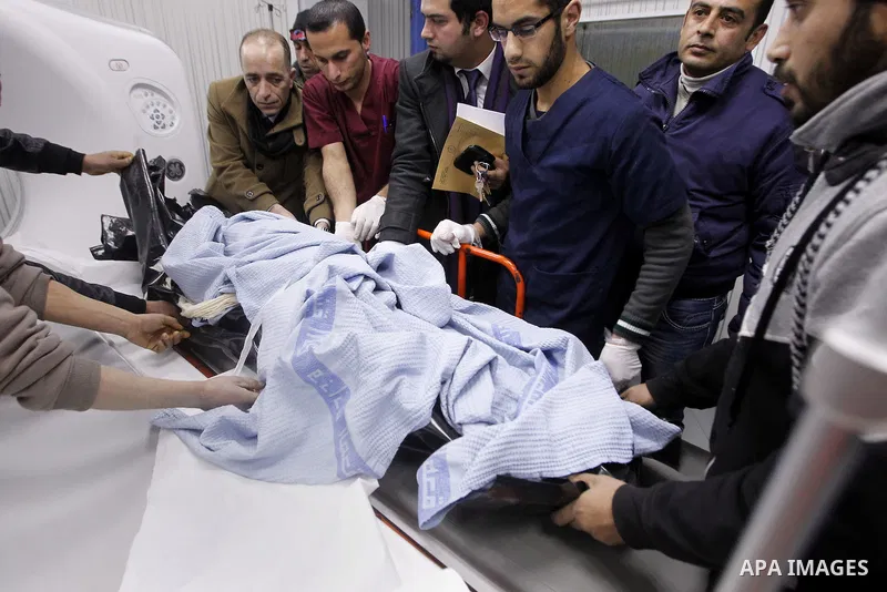 Palestinians mourners gather around the body of 18-year-old Ahmad Younis Kawazba at a hospital in the West Bank city of Hebron on Jan. 05, 2016. Kawazba was shot dead after he reportedly stabbed an Israeli soldier at the...