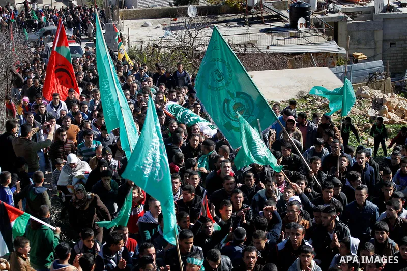 Mourners carry the body of Palestinian Ahmad Kawazbeh, 17, whom the Israeli military said was shot and killed by Israeli security forces on Tuesday after he stabbed an Israeli soldier, during his funeral in the West Bank...