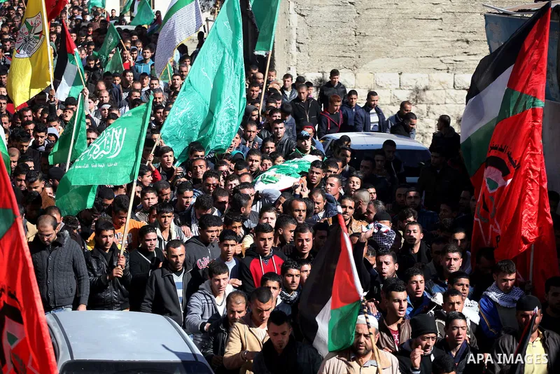 Mourners carry the body of Palestinian Ahmad Kawazbeh, 17, whom the Israeli military said was shot and killed by Israeli security forces on Tuesday after he stabbed an Israeli soldier, during his funeral in the West Bank...