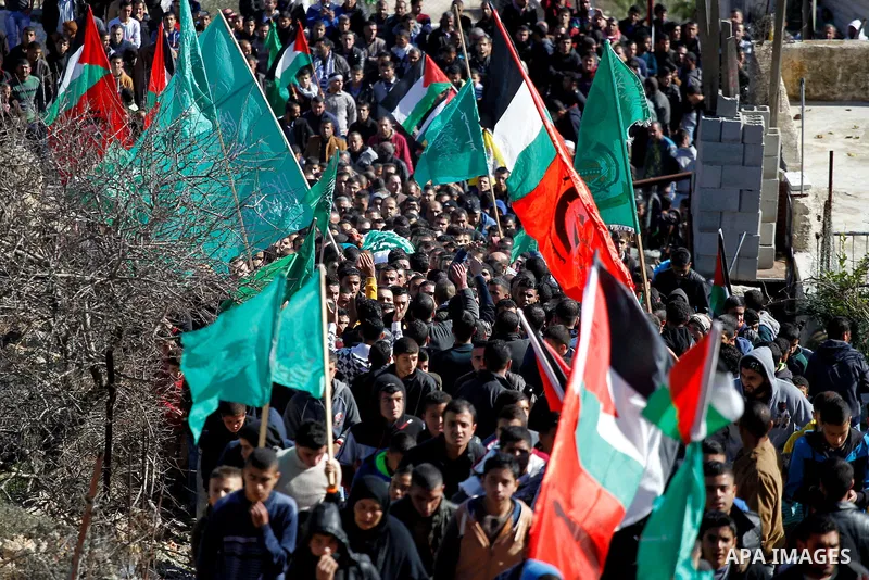 Mourners carry the body of Palestinian Ahmad Kawazbeh, 17, whom the Israeli military said was shot and killed by Israeli security forces on Tuesday after he stabbed an Israeli soldier, during his funeral in the West Bank...