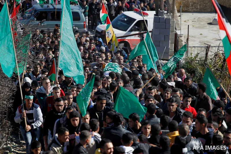 Mourners carry the body of Palestinian Ahmad Kawazbeh, 17, whom the Israeli military said was shot and killed by Israeli security forces on Tuesday after he stabbed an Israeli soldier, during his funeral in the West Bank...