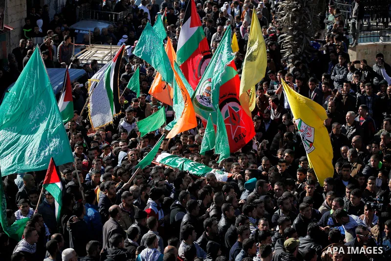 Mourners carry the body of Palestinian Ahmad Kawazbeh, 17, whom the Israeli military said was shot and killed by Israeli security forces on Tuesday after he stabbed an Israeli soldier, during his funeral in the West Bank...