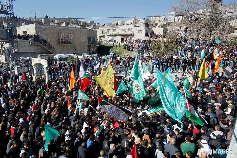 Mourners carry the body of Palestinian Ahmad Kawazbeh, 17, whom the Israeli military said was shot and killed by Israeli security forces on Tuesday after he stabbed an Israeli soldier, during his funeral in the West Bank...