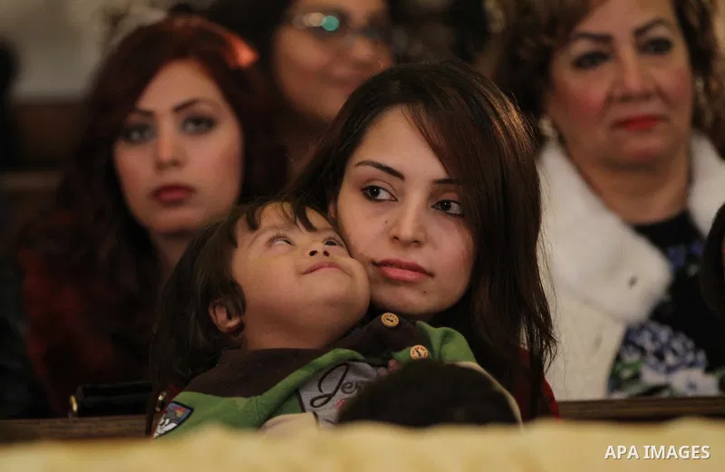 Egyptian Christians take part in the Coptic Orthodox Christmas Eve mass in St. Mark church in Cairo on January 6, 2016. Photo by Stringer