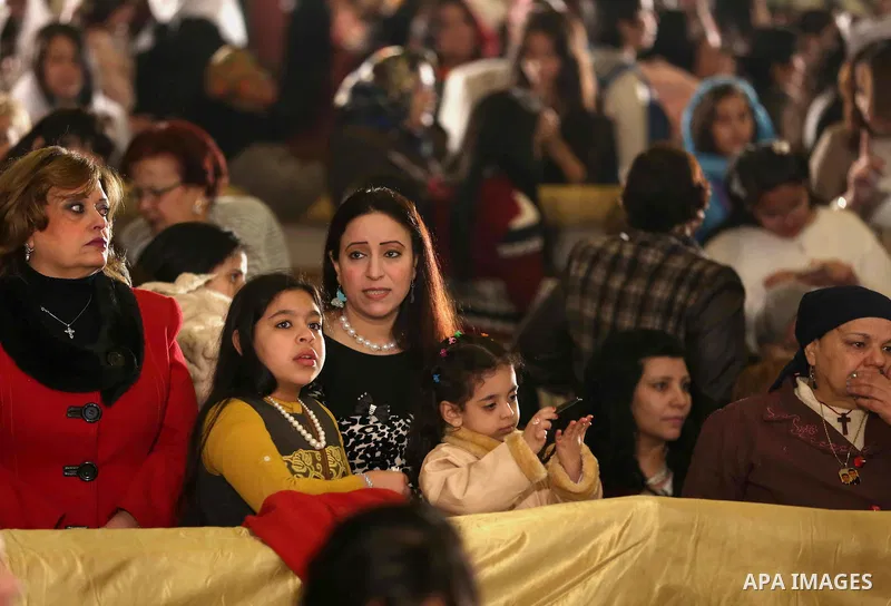 Egyptian Christians take part in the Coptic Orthodox Christmas Eve mass in St. Mark church in Cairo on January 6, 2016. Photo by Stringer