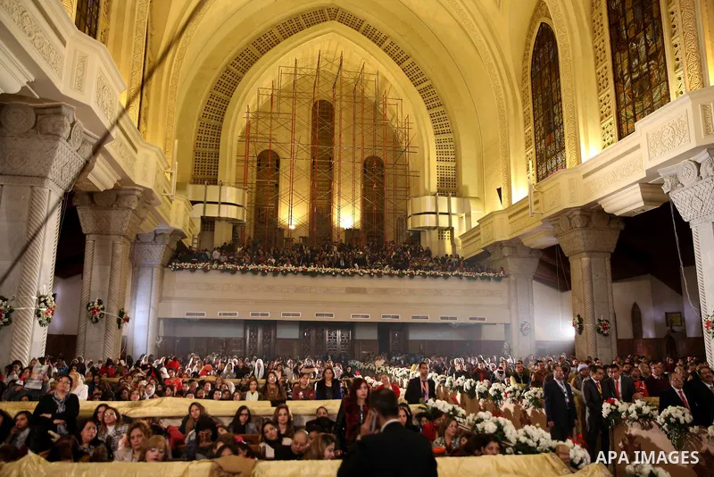 Egyptian Christians take part in the Coptic Orthodox Christmas Eve mass in St. Mark church in Cairo on January 6, 2016. Photo by Stringer