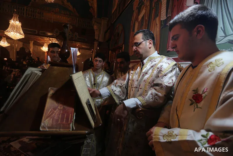 Palestinian Greek Orthodox Christians attend Christmas mass at the Orthodox Saint Porfirios church in Gaza City on January 7, 2016. The Orthodox Church celebrates Christmas and other religious holidays according to the J...