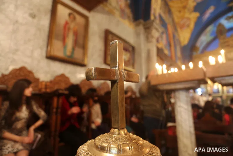 Palestinian Greek Orthodox Christians attend Christmas mass at the Orthodox Saint Porfirios church in Gaza City on January 7, 2016. The Orthodox Church celebrates Christmas and other religious holidays according to the J...