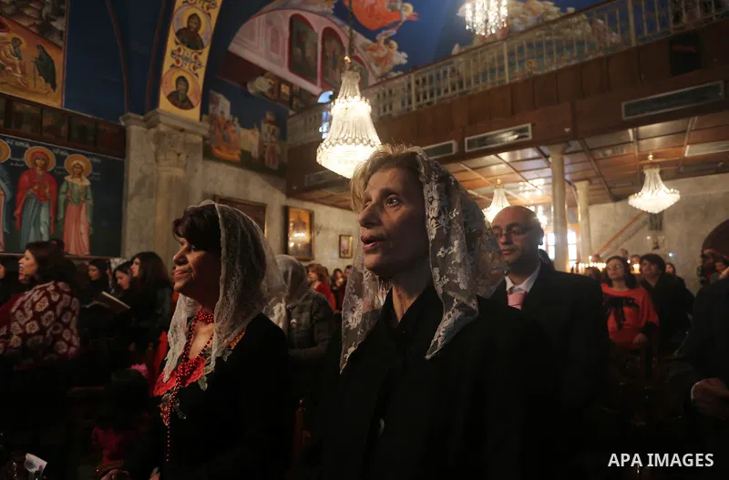 Palestinian Greek Orthodox Christians attend Christmas mass at the Orthodox Saint Porfirios church in Gaza City on January 7, 2016. The Orthodox Church celebrates Christmas and other religious holidays according to the J...