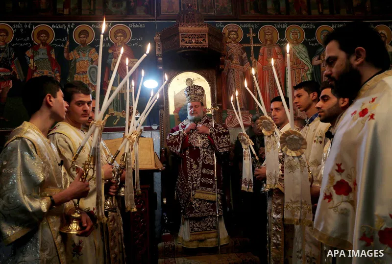 Palestinian Greek Orthodox Christians attend Christmas mass at the Orthodox Saint Porfirios church in Gaza City on January 7, 2016. The Orthodox Church celebrates Christmas and other religious holidays according to the J...
