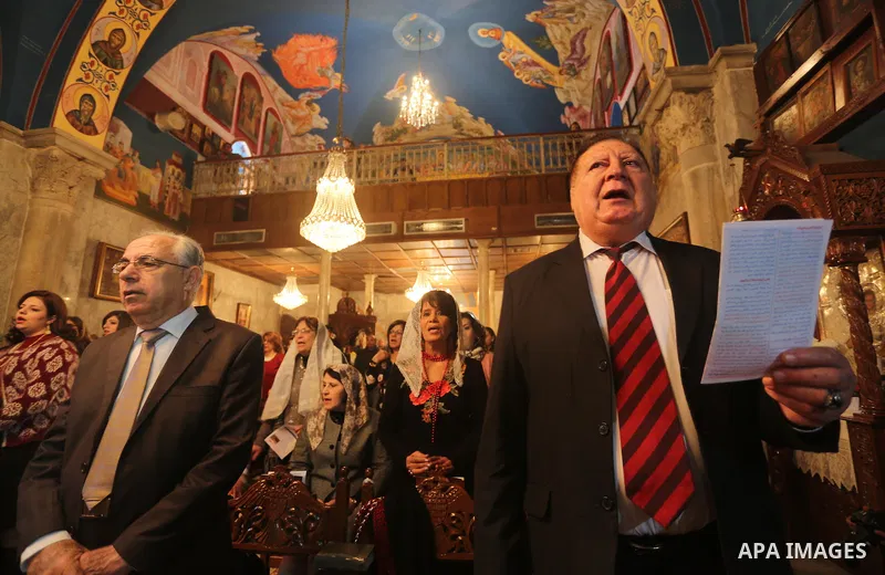 Palestinian Greek Orthodox Christians attend Christmas mass at the Orthodox Saint Porfirios church in Gaza City on January 7, 2016. The Orthodox Church celebrates Christmas and other religious holidays according to the J...