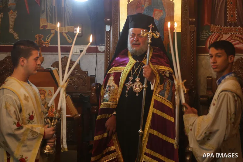 Palestinian Greek Orthodox Christians attend Christmas mass at the Orthodox Saint Porfirios church in Gaza City on January 7, 2016. The Orthodox Church celebrates Christmas and other religious holidays according to the J...