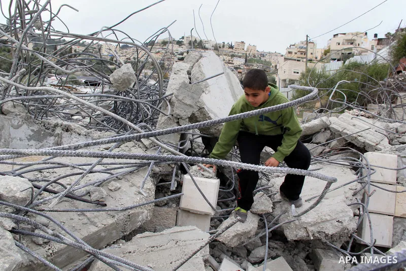 Palestinians inspect their house that was demolished by Jerusalem municipality workers on Jerusalem in Jan. 07, 2016. Israeli police Thursday demolished two Palestinian-owned homes in Ein el-Lawza neighborhood in Jerusal...