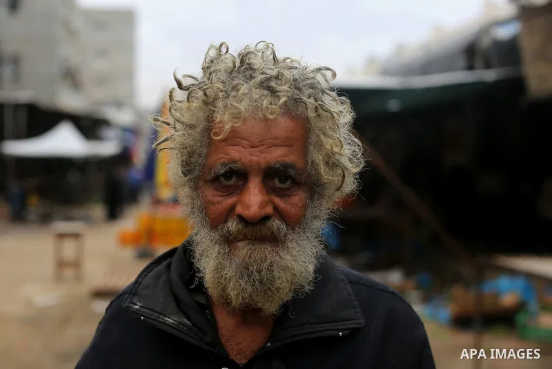 A Palestinian man poses for a photograph at the market in Shati refugee camp in Gaza city on Jan. 07, 2016. Photo by Ezz al-Zanoun
