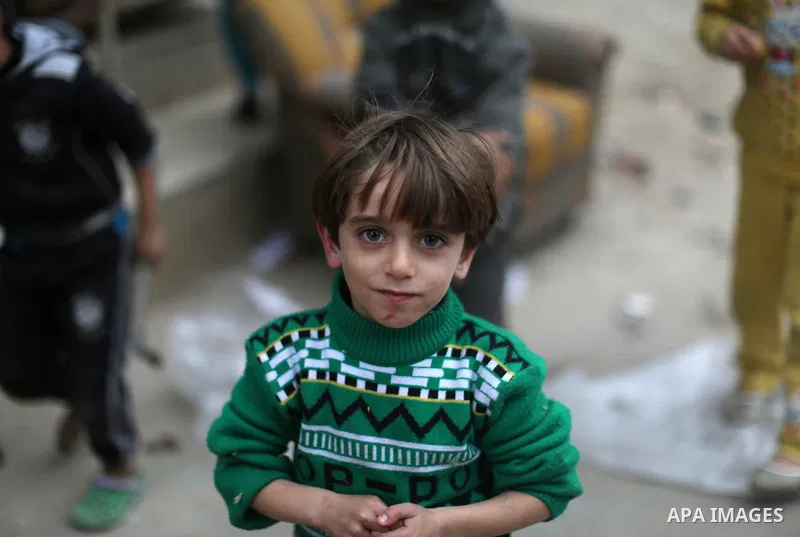 A Palestinian boy poses for a photograph at the market in Shati refugee camp in Gaza city on Jan. 07, 2016. Photo by Ezz al-Zanoun