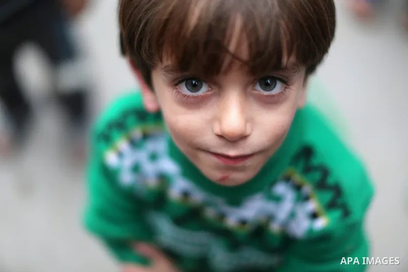A Palestinian boy poses for a photograph at the market in Shati refugee camp in Gaza city on Jan. 07, 2016. Photo by Ezz al-Zanoun