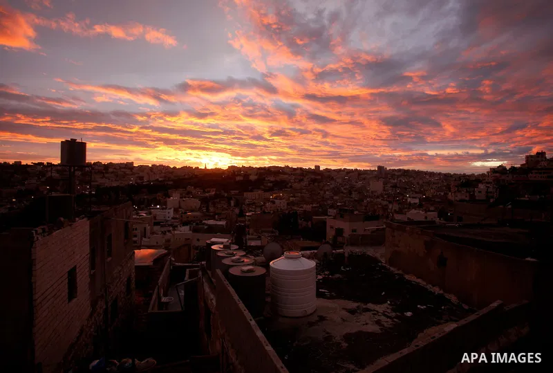 Sunset is seen over the West Bank city of Hebron on Jan. 07, 2016. Photo by Wisam Hashlamoun