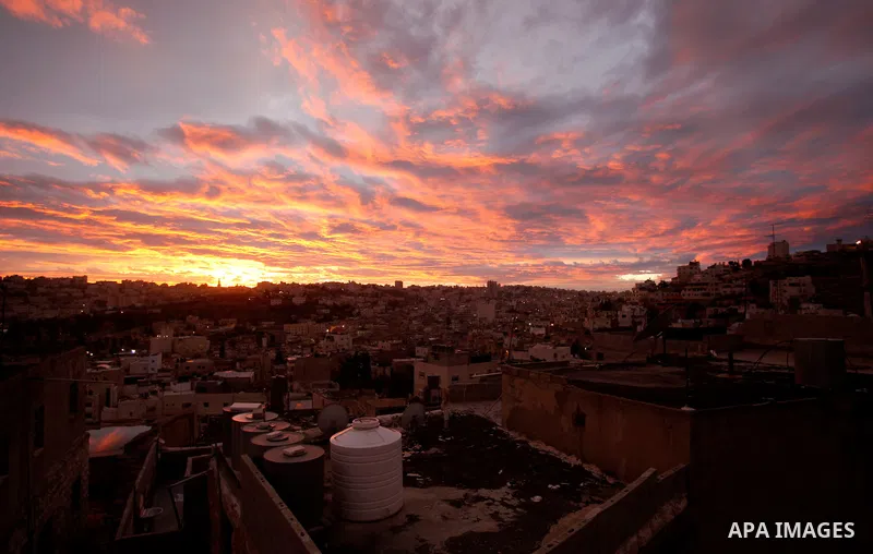 Sunset is seen over the West Bank city of Hebron on Jan. 07, 2016. Photo by Wisam Hashlamoun