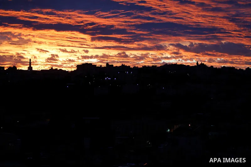 Sunset is seen over the West Bank city of Hebron on Jan. 07, 2016. Photo by Wisam Hashlamoun