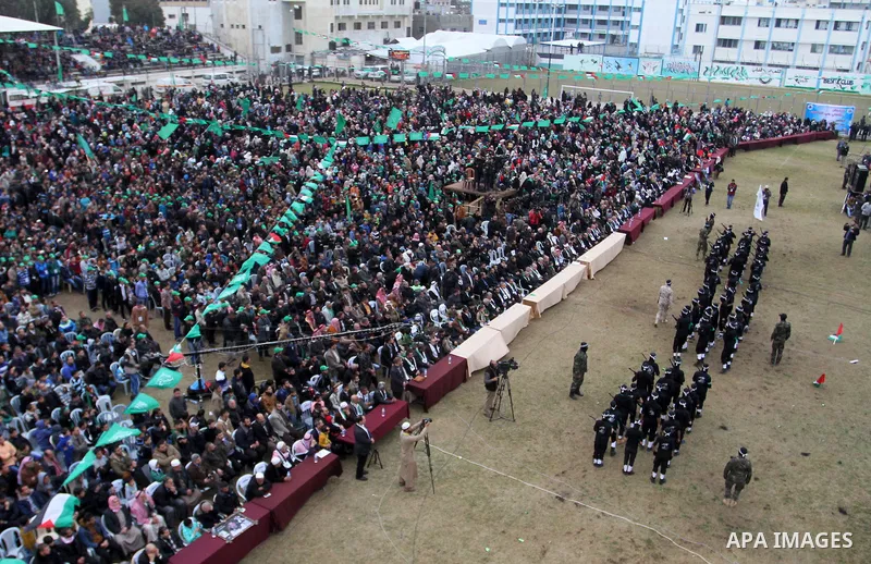 Young Palestinians loyal to the Hamas movement march during a rally in Khan Yunis in the southern Gaza Strip on January 7, 2016. The rally was held to honor the families of dead militants from the armed wing, who Hamas s...