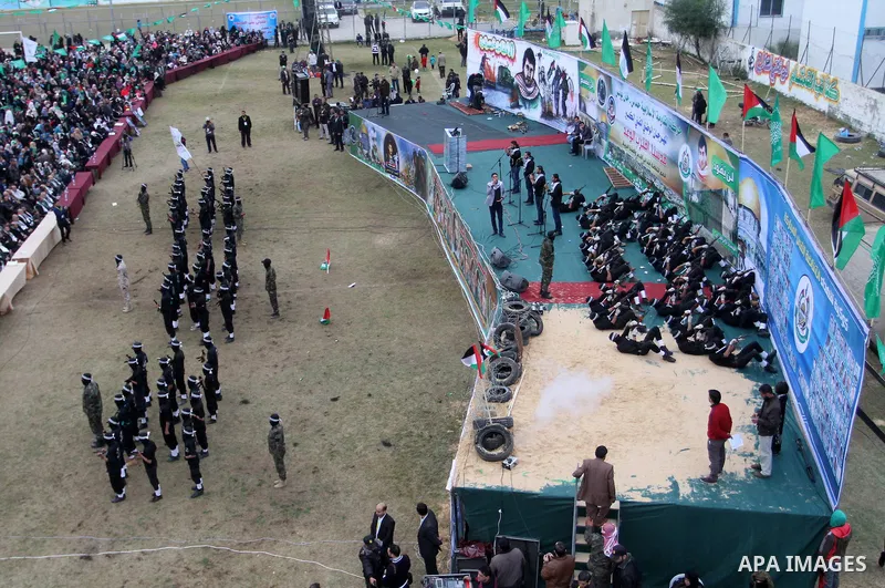 Young Palestinians loyal to the Hamas movement march during a rally in Khan Yunis in the southern Gaza Strip on January 7, 2016. The rally was held to honor the families of dead militants from the armed wing, who Hamas s...