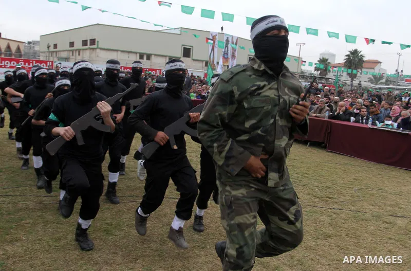 Young Palestinians loyal to the Hamas movement march during a rally in Khan Yunis in the southern Gaza Strip on January 7, 2016. The rally was held to honor the families of dead militants from the armed wing, who Hamas s...
