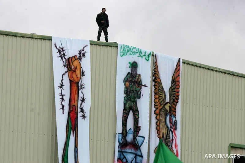 A Palestinian loyal to the Hamas movement watches a rally in Khan Yunis in the southern Gaza Strip on January 7, 2016. The rally was held to honor the families of dead militants from the armed wing, who Hamas said partic...