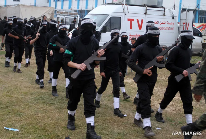 Young Palestinians loyal to the Hamas movement march during a rally in Khan Yunis in the southern Gaza Strip on January 7, 2016. The rally was held to honor the families of dead militants from the armed wing, who Hamas s...