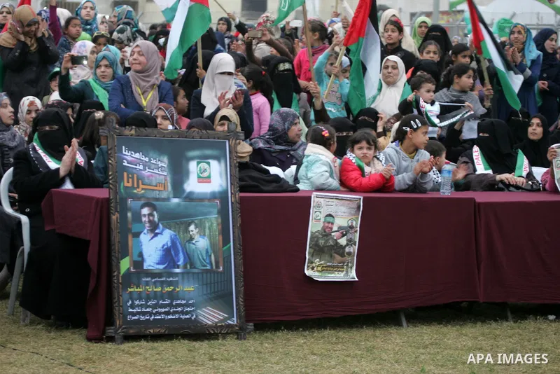 Palestinians attend a rally by Hamas militants in Khan Yunis in the southern Gaza Strip on January 7, 2016. The rally was held to honor the families of dead militants from the armed wing, who Hamas said participated in i...