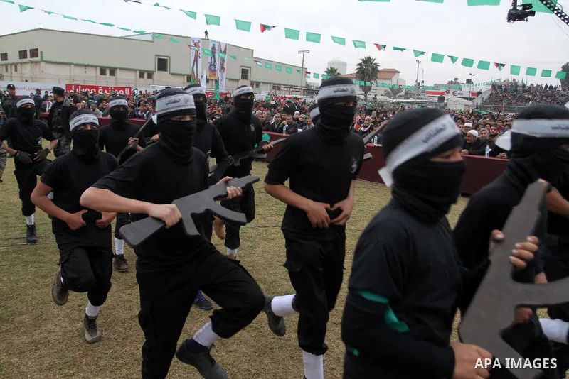 Young Palestinians loyal to the Hamas movement march during a rally in Khan Yunis in the southern Gaza Strip on January 7, 2016. The rally was held to honor the families of dead militants from the armed wing, who Hamas s...