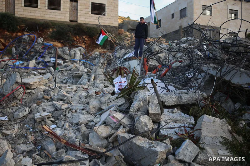 Palestinians look at the rubble of the house of Mohannad Halabi that was demolished by Israeli bulldozers in the West Bank city of Ramallah, Jan. 09, 2016. Halabi killed two Israeli settlers and wounded two more in a kni...