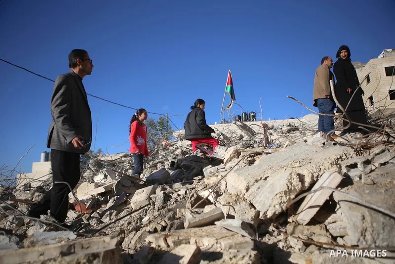 Palestinians look at the rubble of the house of Mohannad Halabi that was demolished by Israeli bulldozers in the West Bank city of Ramallah, Jan. 09, 2016. Halabi killed two Israeli settlers and wounded two more in a kni...