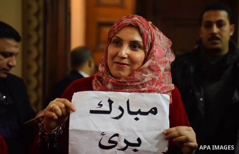 Egyptian supporters of ousted president Hosni Mubarak react inside the courtroom in Cairo on January 9, 2016, after top appeals court upheld upheld a three-year prison sentence for Mubarak and his two sons for corruption...