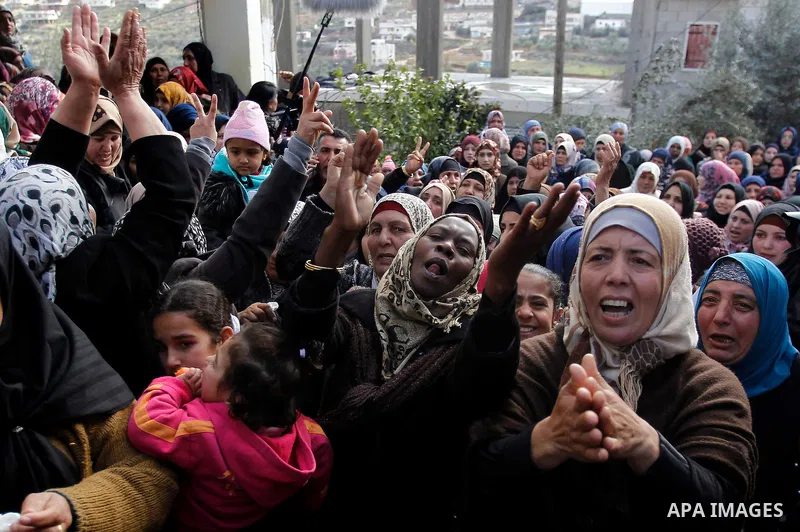 Relatives of one of four Palestinians, who were killed by Israeli security forces after they perpetrated attacks in the southern West Bank, mourn during their funeral in the West Bank village of Sair on January 9, 2016,...