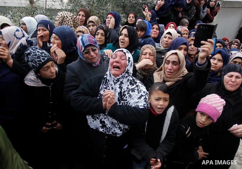 Relatives of one of four Palestinians, who were killed by Israeli security forces after they perpetrated attacks in the southern West Bank, mourn during their funeral in the West Bank village of Sair on January 9, 2016,...