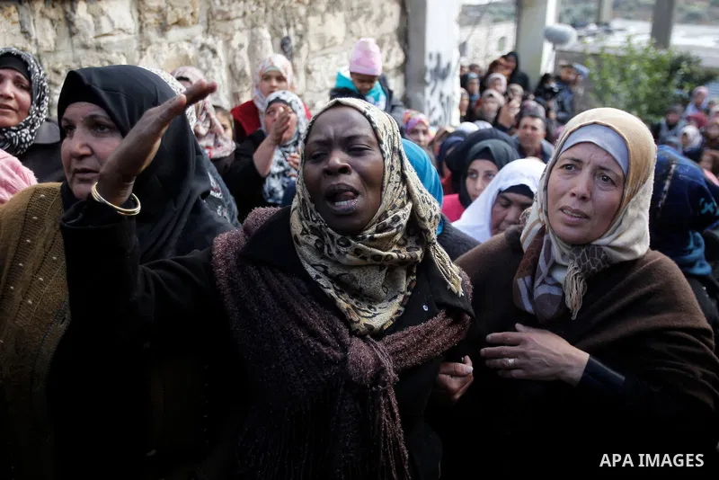 Relatives of one of four Palestinians, who were killed by Israeli security forces after they perpetrated attacks in the southern West Bank, mourn during their funeral in the West Bank village of Sair on January 9, 2016,...