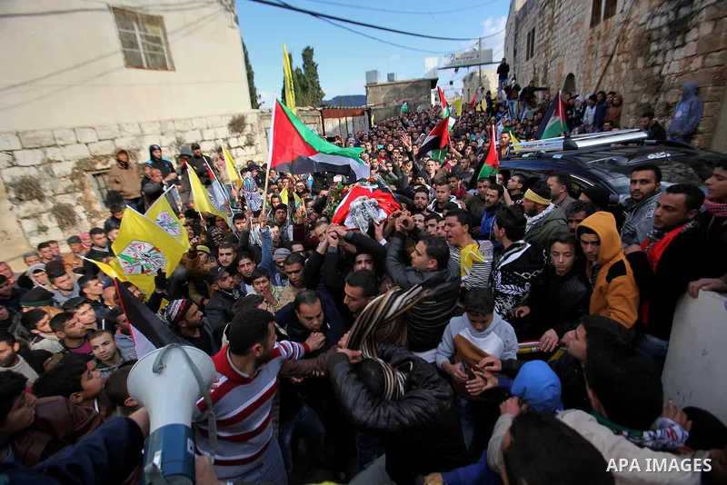 Mourners carry the body of Palestinian Ali Abu Maryam, 22 , who was killed by Israeli troops, during his funeral in the West Bank of jenin, on January 9, 2016. Israeli troops shot dead two Palestinian men at a checkpoint...