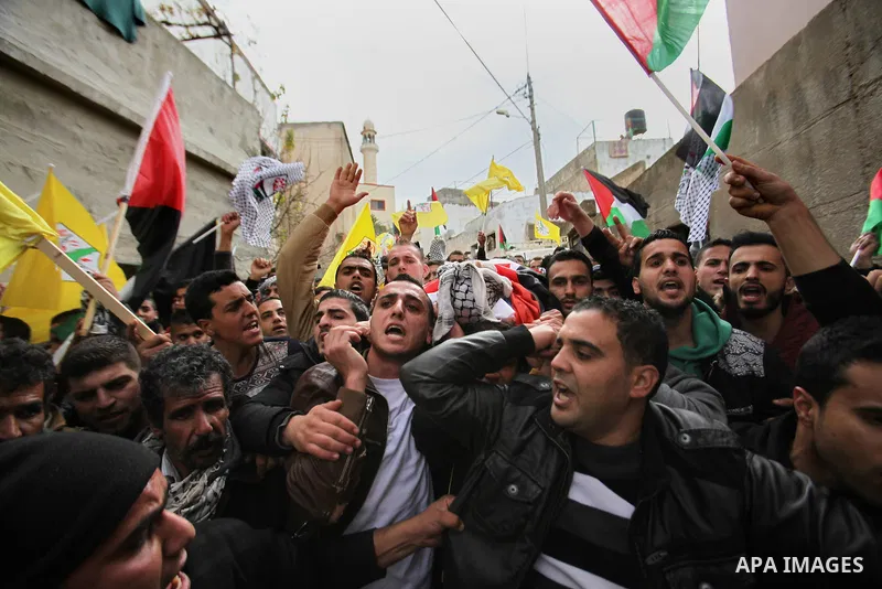 Mourners carry the body of Palestinian Ali Abu Maryam, 22 , who was killed by Israeli troops, during his funeral in the West Bank of jenin, on January 9, 2016. Israeli troops shot dead two Palestinian men at a checkpoint...