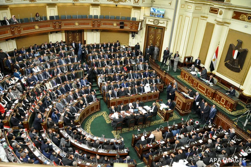 Staff members attend the swearing-in session of the Parliament during the first meeting of Egypt's newly elected parliament, inside the People's Assembly for the opening session of the new parliament in Cairo, Egypt, on...