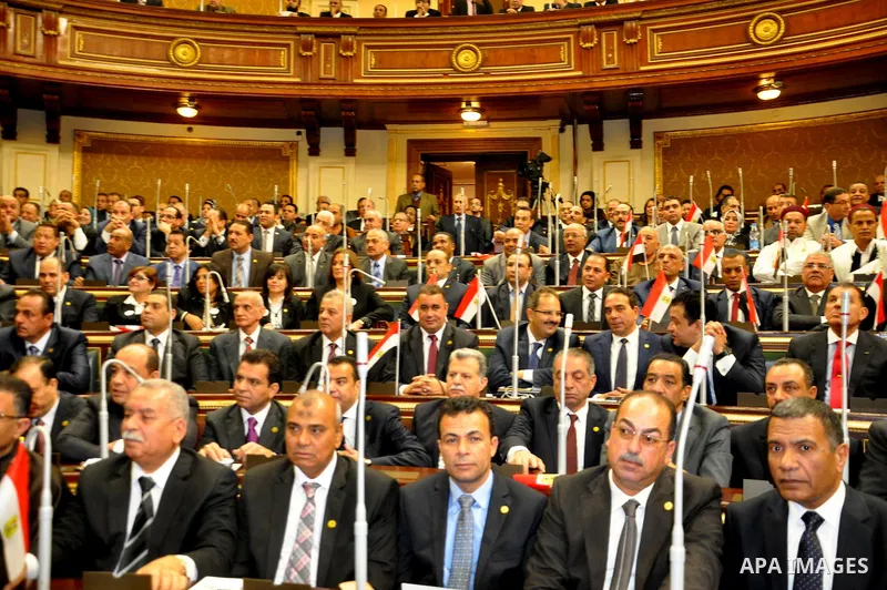 Staff members attend the swearing-in session of the Parliament during the first meeting of Egypt's newly elected parliament, inside the People's Assembly for the opening session of the new parliament in Cairo, Egypt, on...