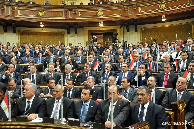 Staff members attend the swearing-in session of the Parliament during the first meeting of Egypt's newly elected parliament, inside the People's Assembly for the opening session of the new parliament in Cairo, Egypt, on...