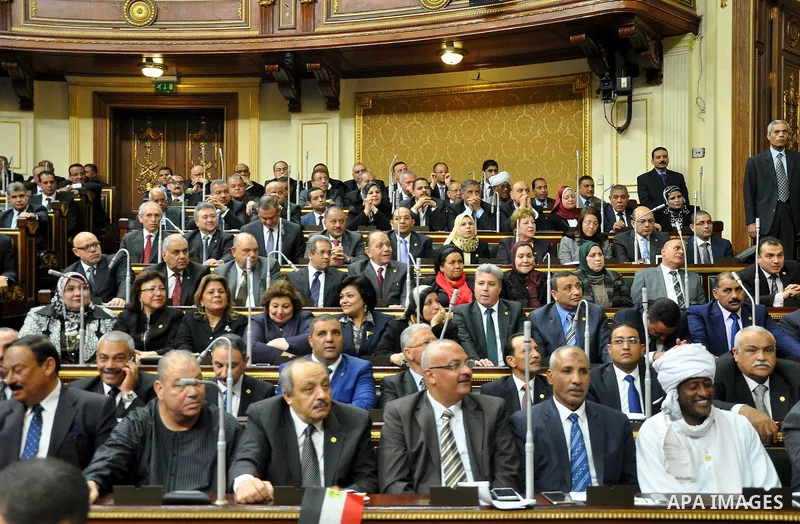 Staff members attend the swearing-in session of the Parliament during the first meeting of Egypt's newly elected parliament, inside the People's Assembly for the opening session of the new parliament in Cairo, Egypt, on...