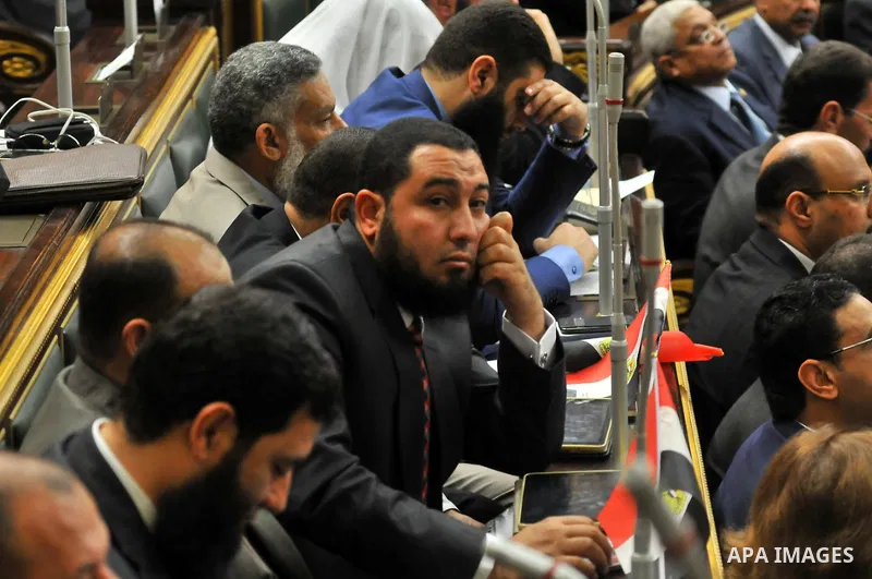 Staff members attend the swearing-in session of the Parliament during the first meeting of Egypt's newly elected parliament, inside the People's Assembly for the opening session of the new parliament in Cairo, Egypt, on...