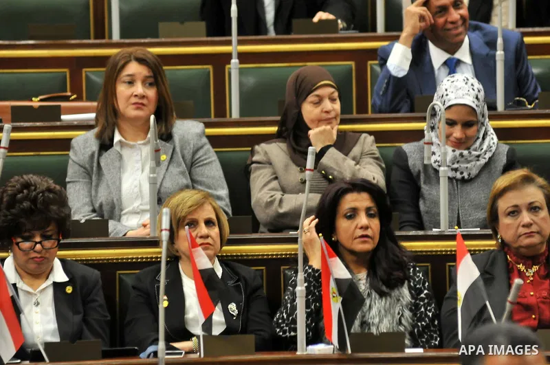 Staff members attend the swearing-in session of the Parliament during the first meeting of Egypt's newly elected parliament, inside the People's Assembly for the opening session of the new parliament in Cairo, Egypt, on...