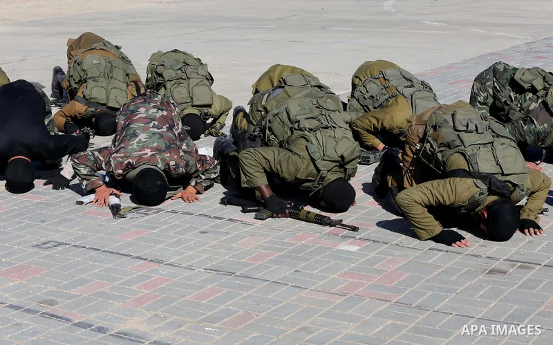 Members of Palestinian security forces loyal to Hamas demonstrate their skills during a military graduation ceremony in Gaza City January 10, 2016. Photo by Mohammed Asad
