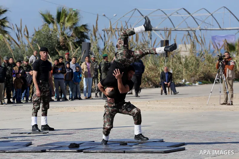 Members of Palestinian security forces loyal to Hamas demonstrate their skills during a military graduation ceremony in Gaza City January 10, 2016. Photo by Mohammed Asad