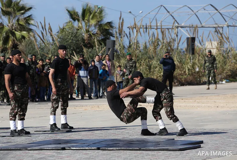 Members of Palestinian security forces loyal to Hamas demonstrate their skills during a military graduation ceremony in Gaza City January 10, 2016. Photo by Mohammed Asad