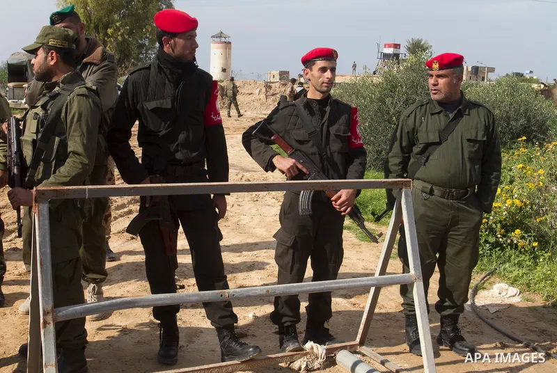 Palestinian officers stand guard during a protest demanding for Palestinian men abducted by unidentified masked gunmen, in front of the Gaza-Egypt border in Rafah in the southern Gaza Strip, on January 11, 2016. Photo by...